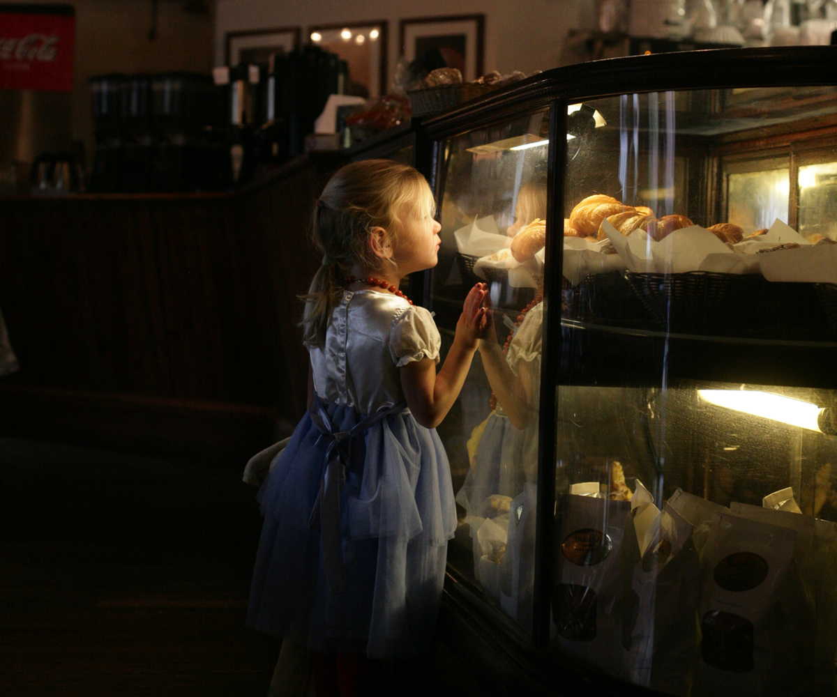Little girl peering into the cookie case at Merridee's